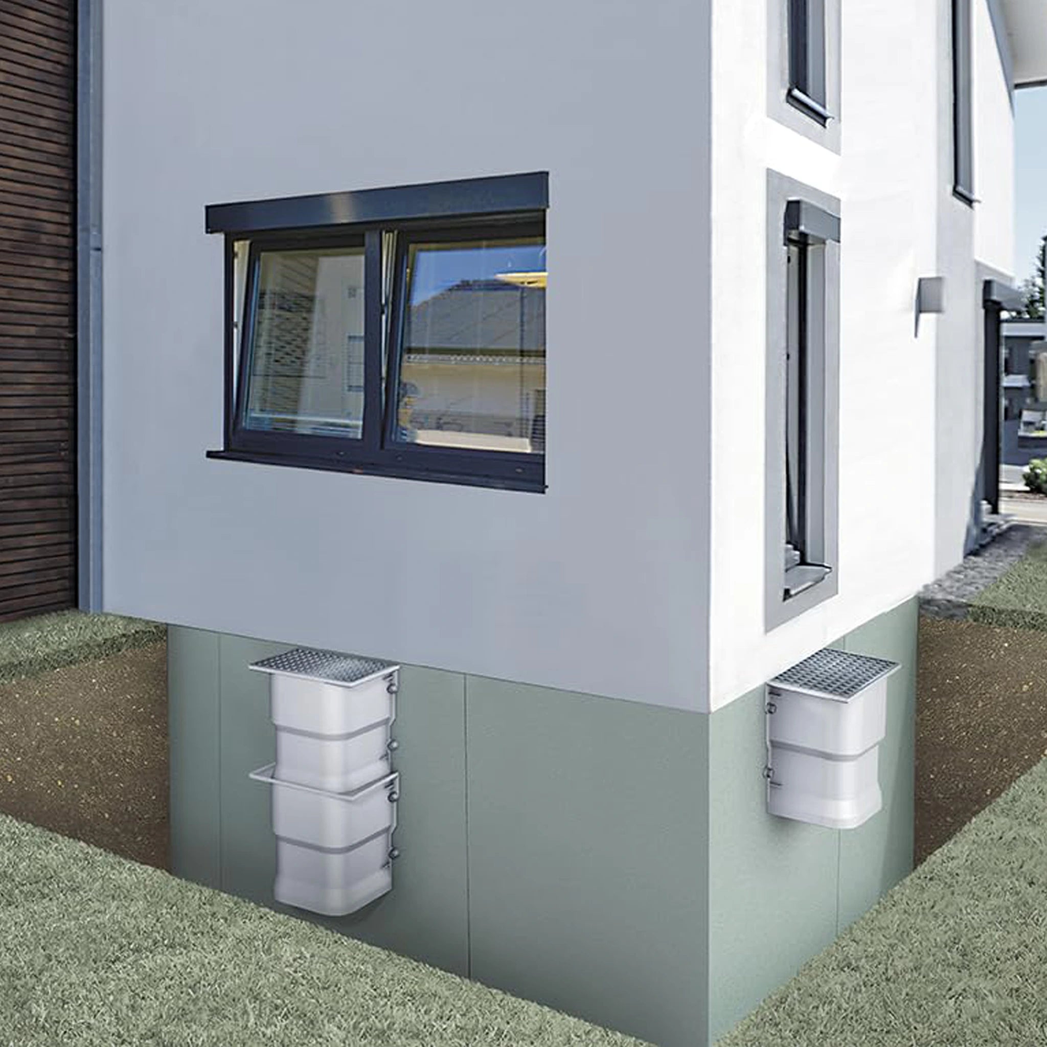 Deux courettes d’aération SMC installées – solution durable et efficace pour ventiler et assainir naturellement les sous-sols humides.